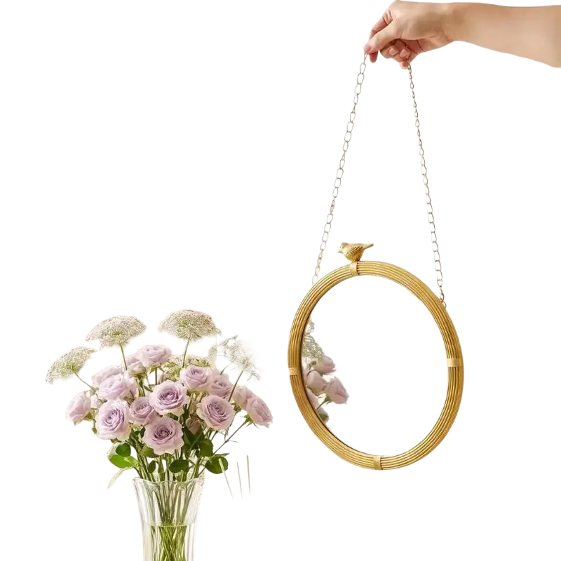Decorative mirrour with a gold-toned resin frame and bird detail for stylish interior wall decor