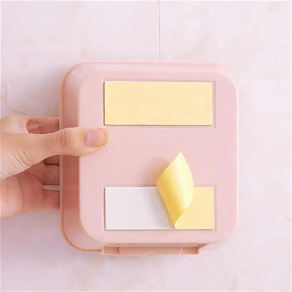 Pastel wall mounted vanity organizer pink plastic sticky note dispenser with two slots holding yellow and white notes