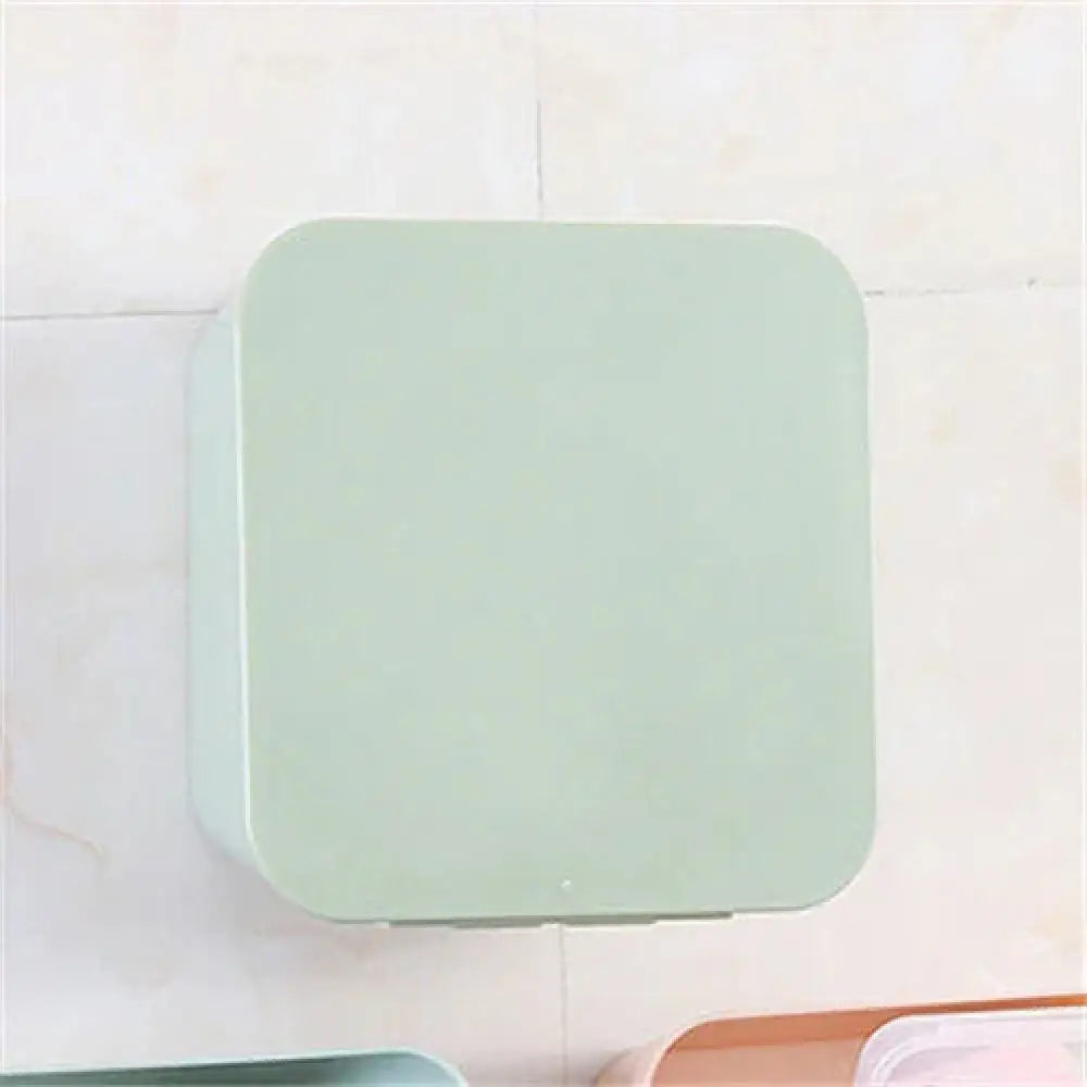 A sleek matte mint green pastel wall mounted vanity organizer with rounded edges for makeup storage