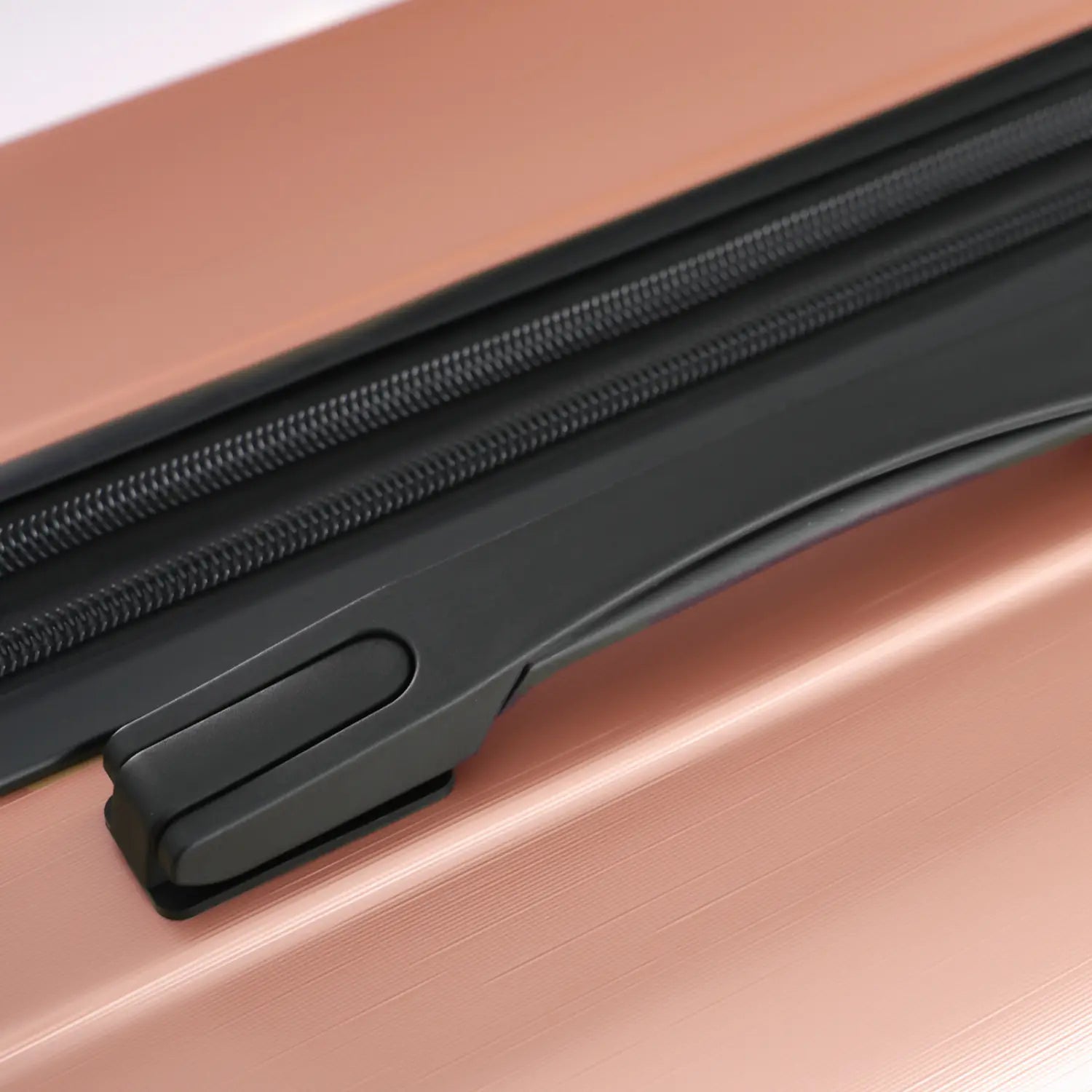 Rose gold 28 inch expandable hardshell spinner suitcase with black zipper and pull tab.