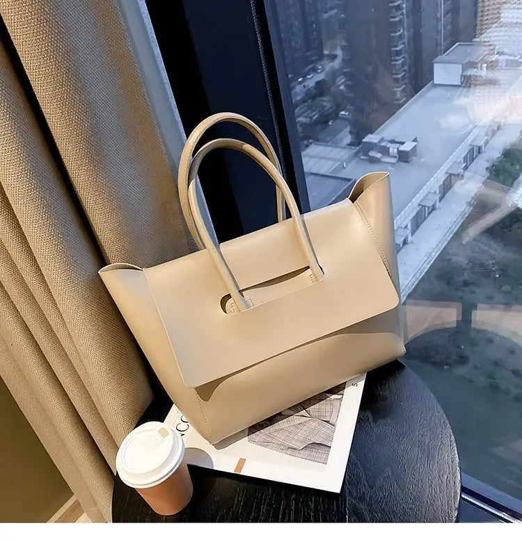 Beige leather vintage structured tote bag with top handles and a durable design.