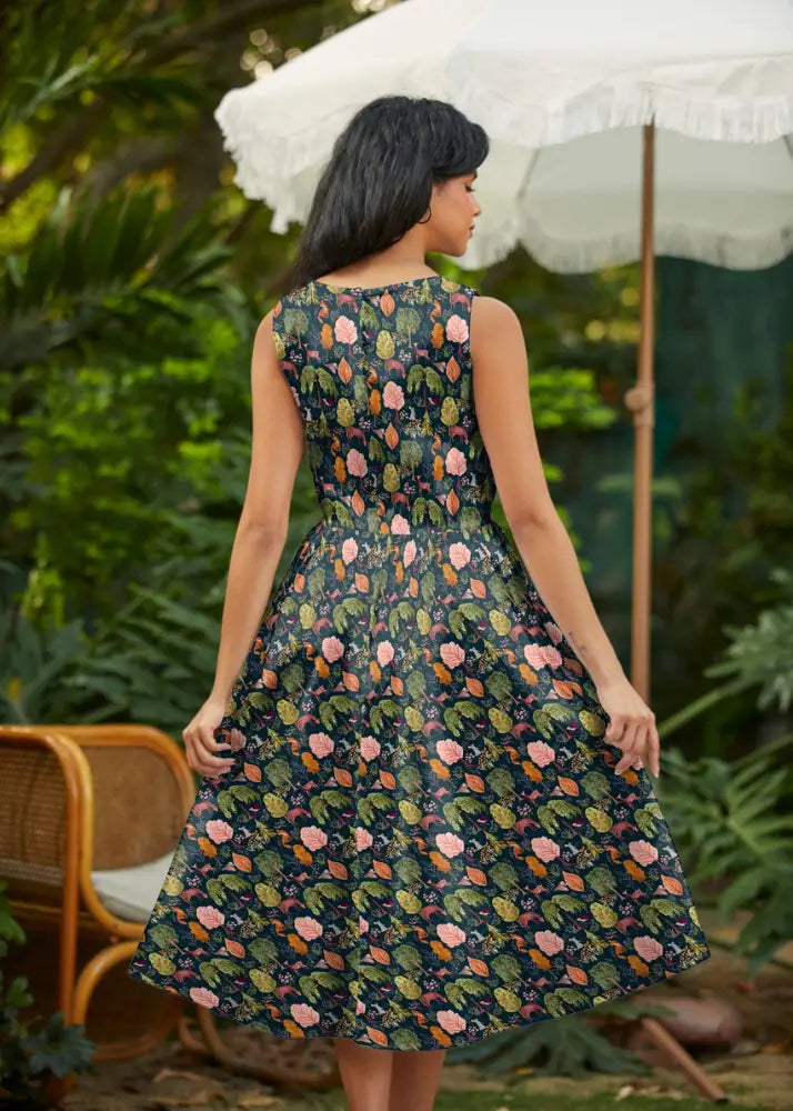 A sleeveless dark green cotton midi dress with pink and orange floral print and pockets vintage style