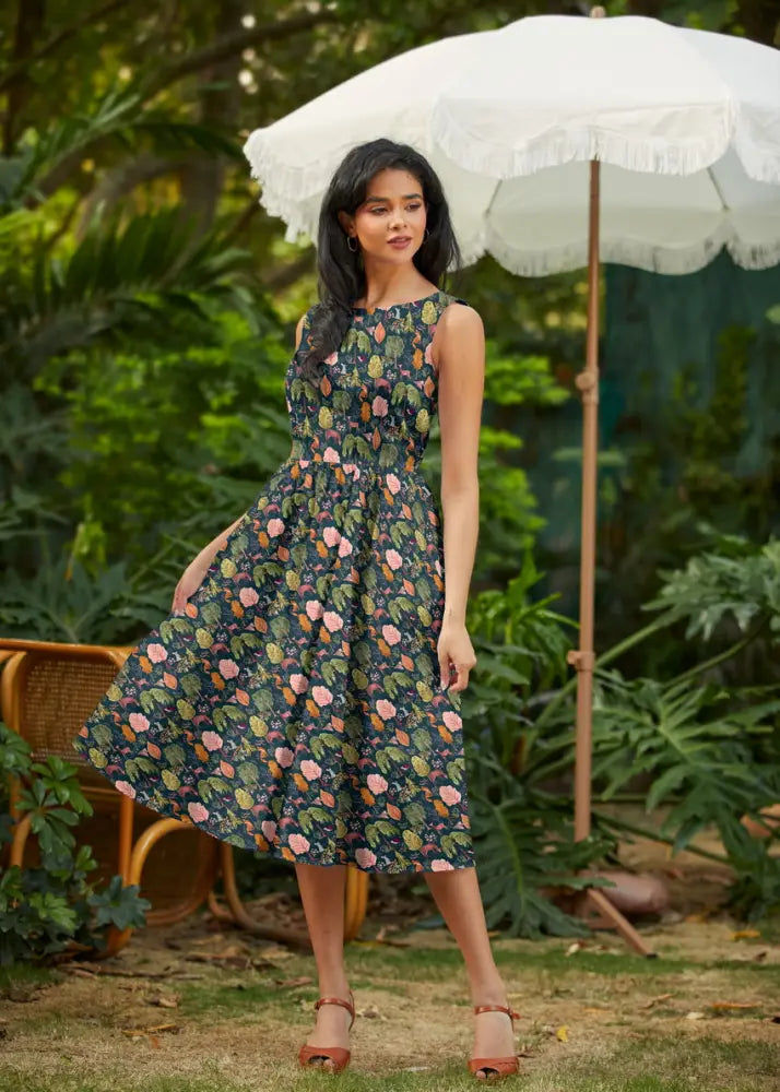 A sleeveless dark navy cotton midi dress with pink and green floral print and pockets vintage floral deer design