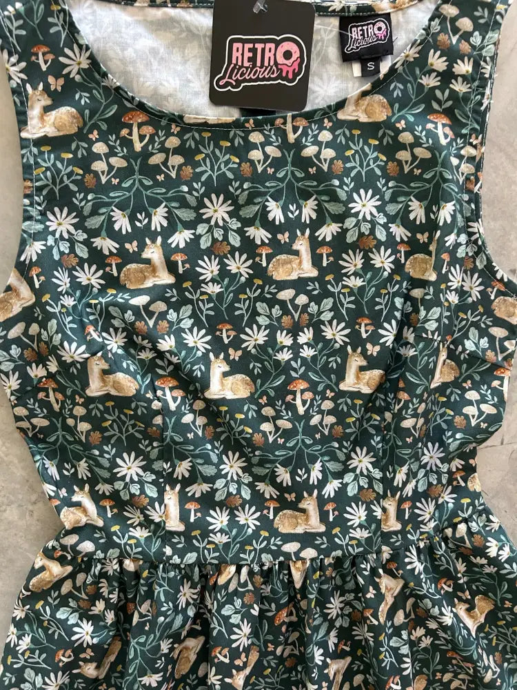 Sleeveless dark green cotton midi dress with pockets featuring a vintage floral deer print and whimsical pattern