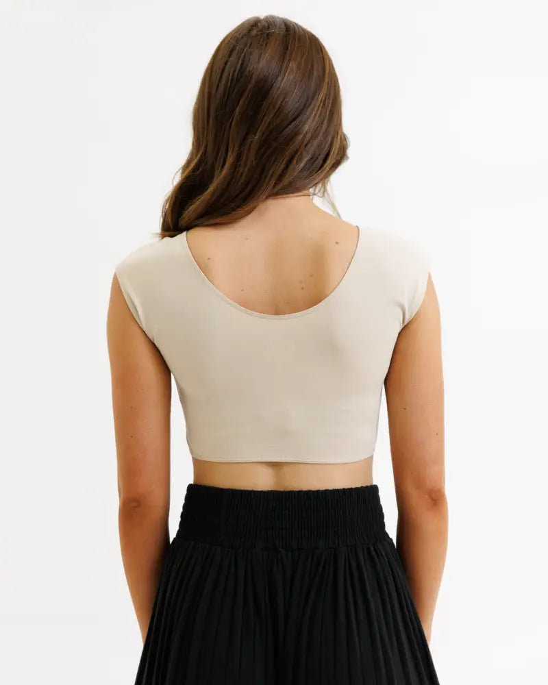 Beige demi tri blend fitted crop tee with short sleeves and round back neckline shown from the back side