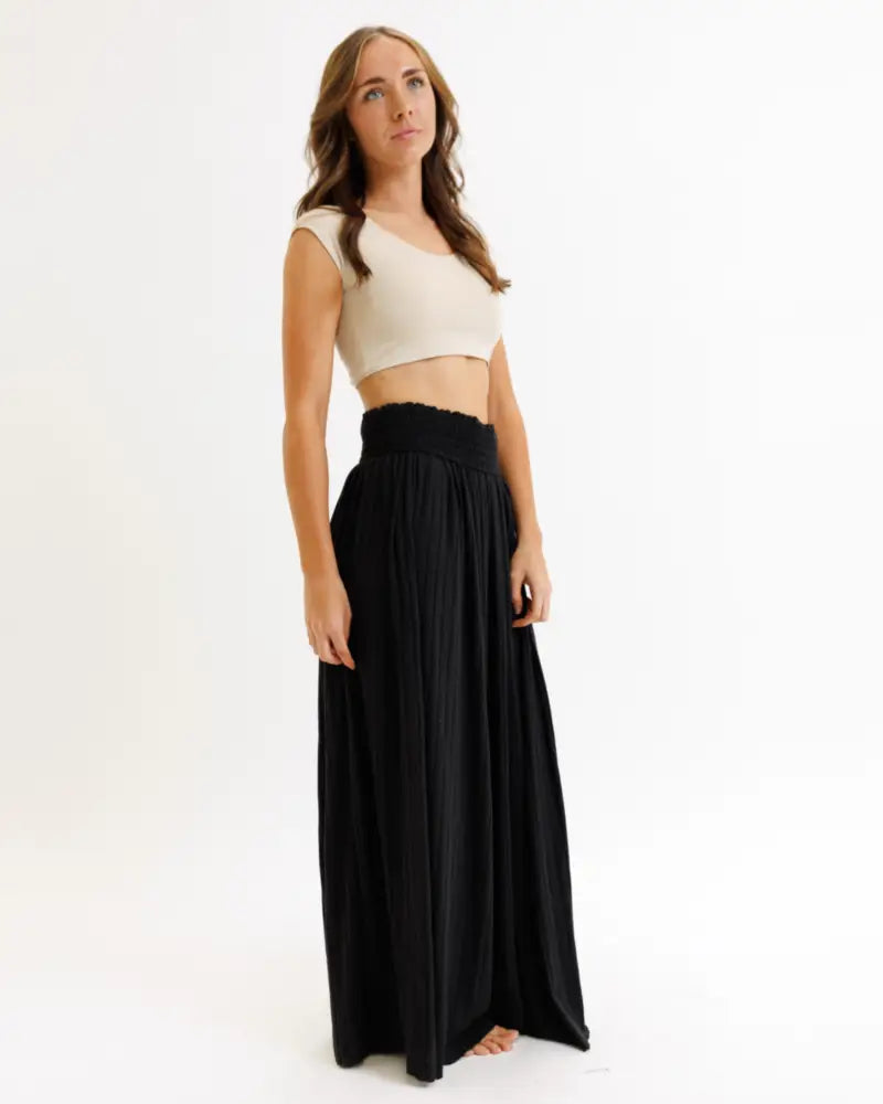 Black high-waisted maxi skirt with gathered elastic waistband paired with demi tri blend scoop neck fitted crop tee