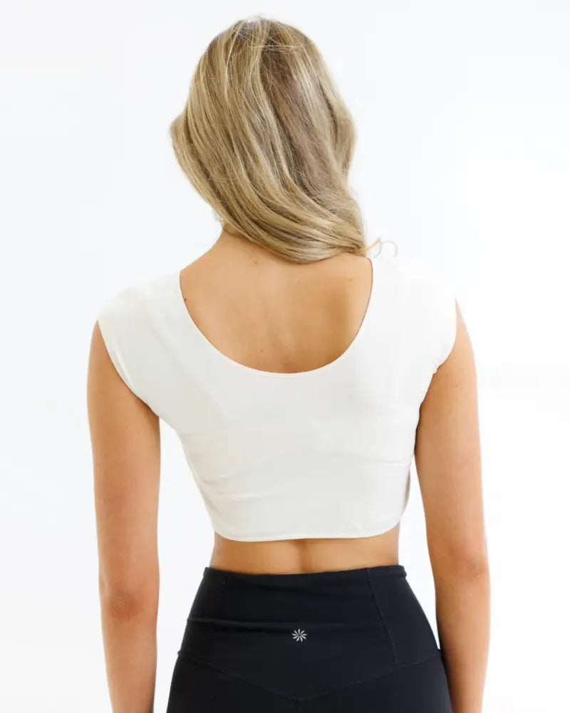 White demi tri blend fitted crop tee with a scoop neck and rounded back neckline showing subtle side seam details