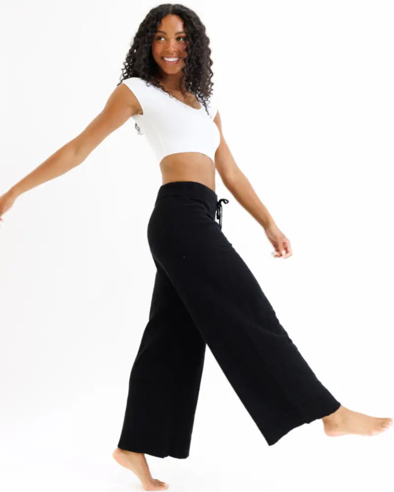 Black wide-leg pants with a drawstring waistband paired with a demi tri blend scoop neck fitted crop tee