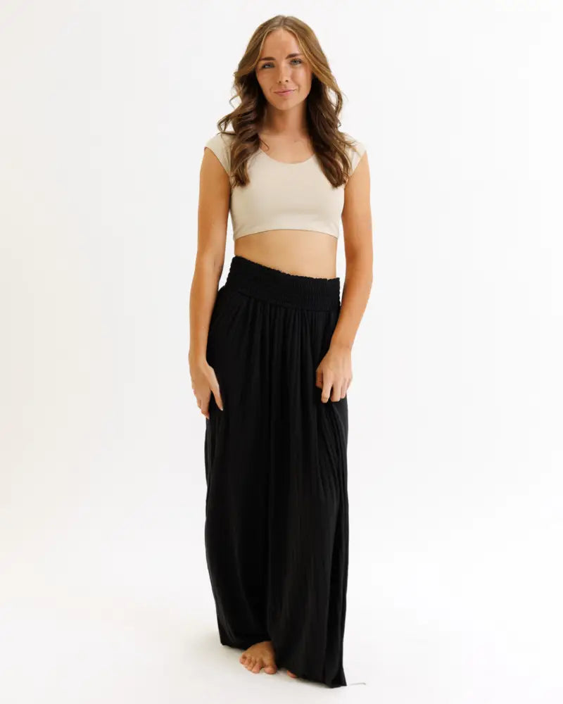 Black high-waisted wide-leg pants with gathered elastic waistband paired with demi tri blend scoop neck fitted crop tee