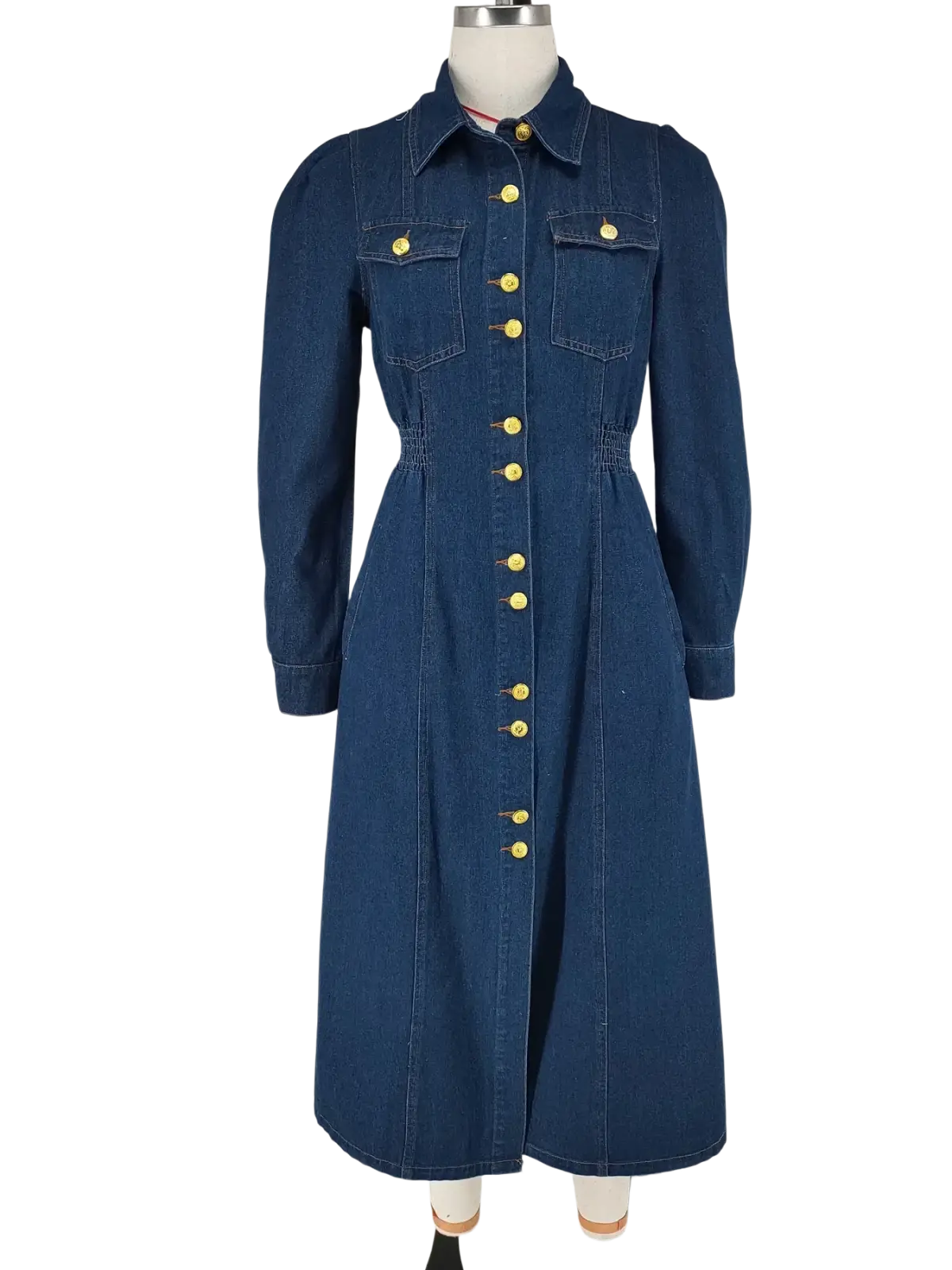 A navy blue denim dress with long sleeves gold-tone buttons collar and two front pockets for casual wear