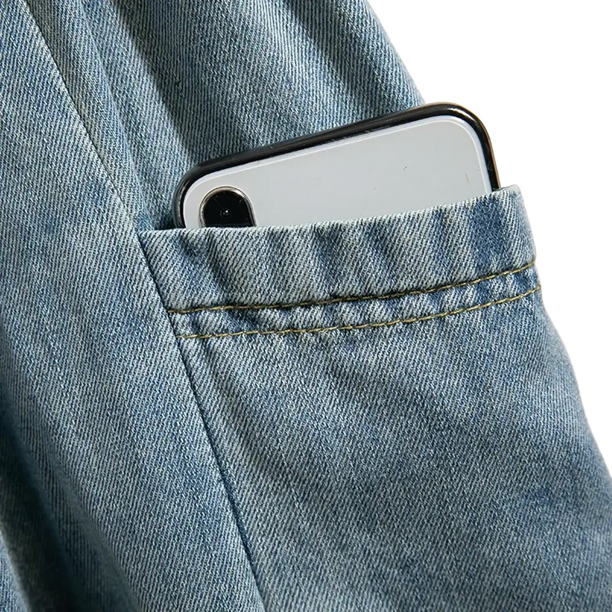 Denim a-line midi skirt in light-wash denim with vintage button front and a silver smartphone partially visible in pocket