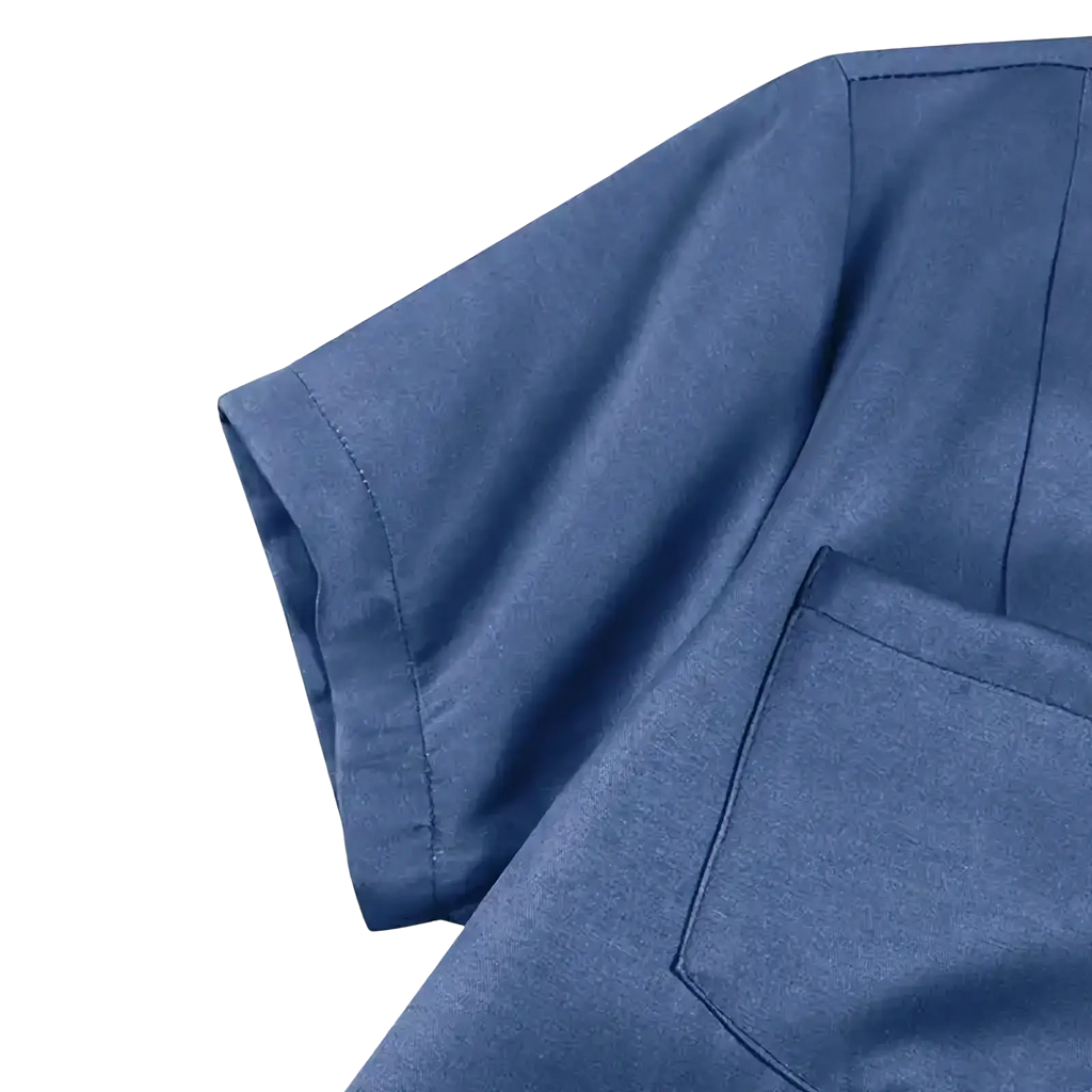 Denim maxi dress with button down front and ruffle hem paired with a blue short-sleeved shirt with chest pocket