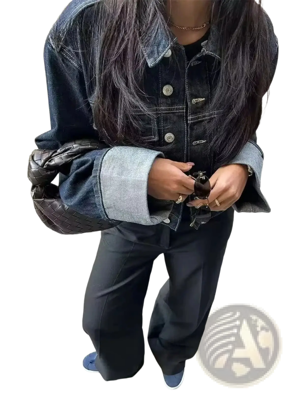 Black woven leather handbag with a distinctive knot design paired with a denim outfit set featuring vintage wide leg jeans and crop jacket