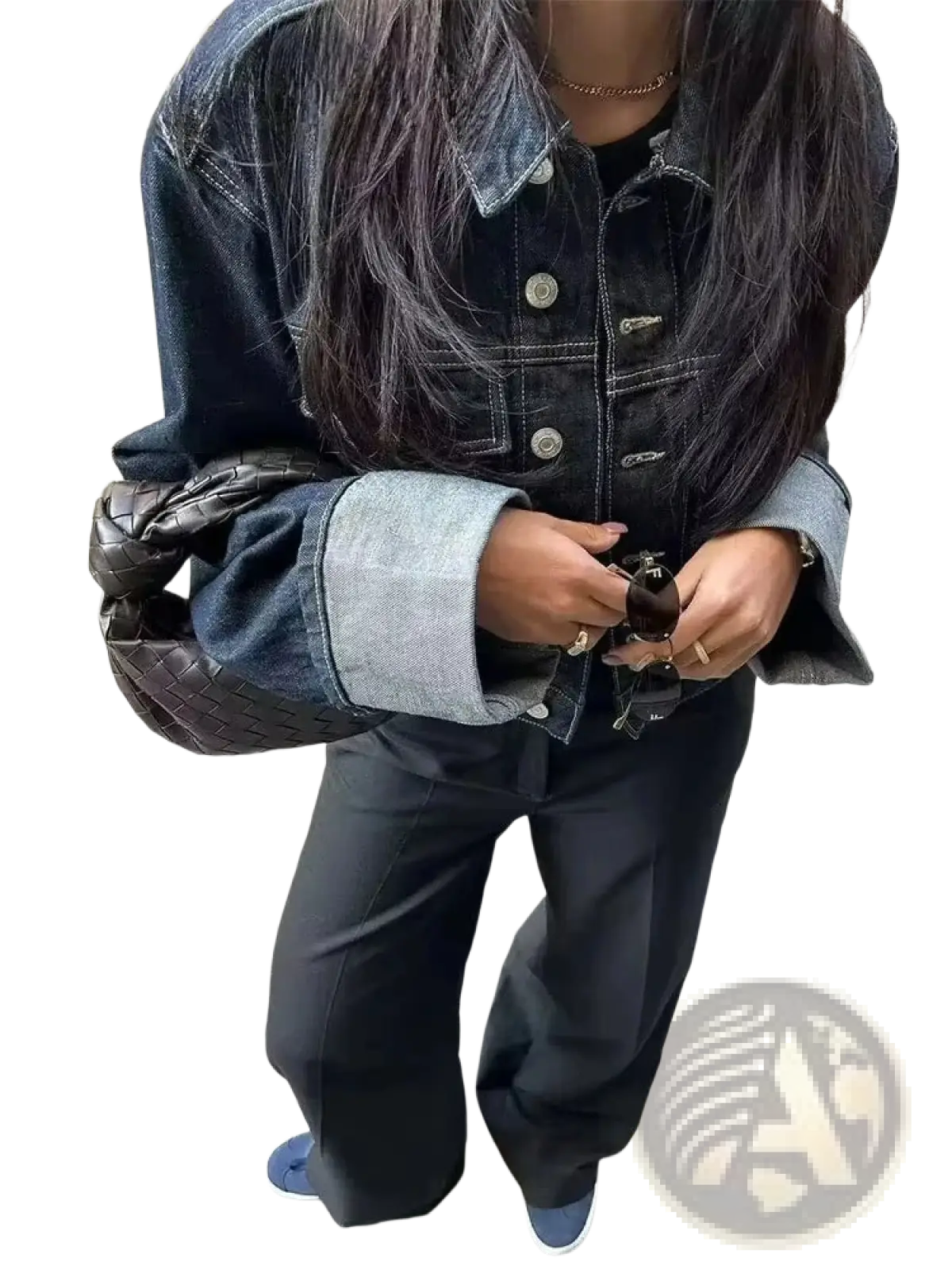 Black woven leather handbag with a distinctive knot design paired with a denim outfit set featuring vintage wide leg jeans and crop jacket
