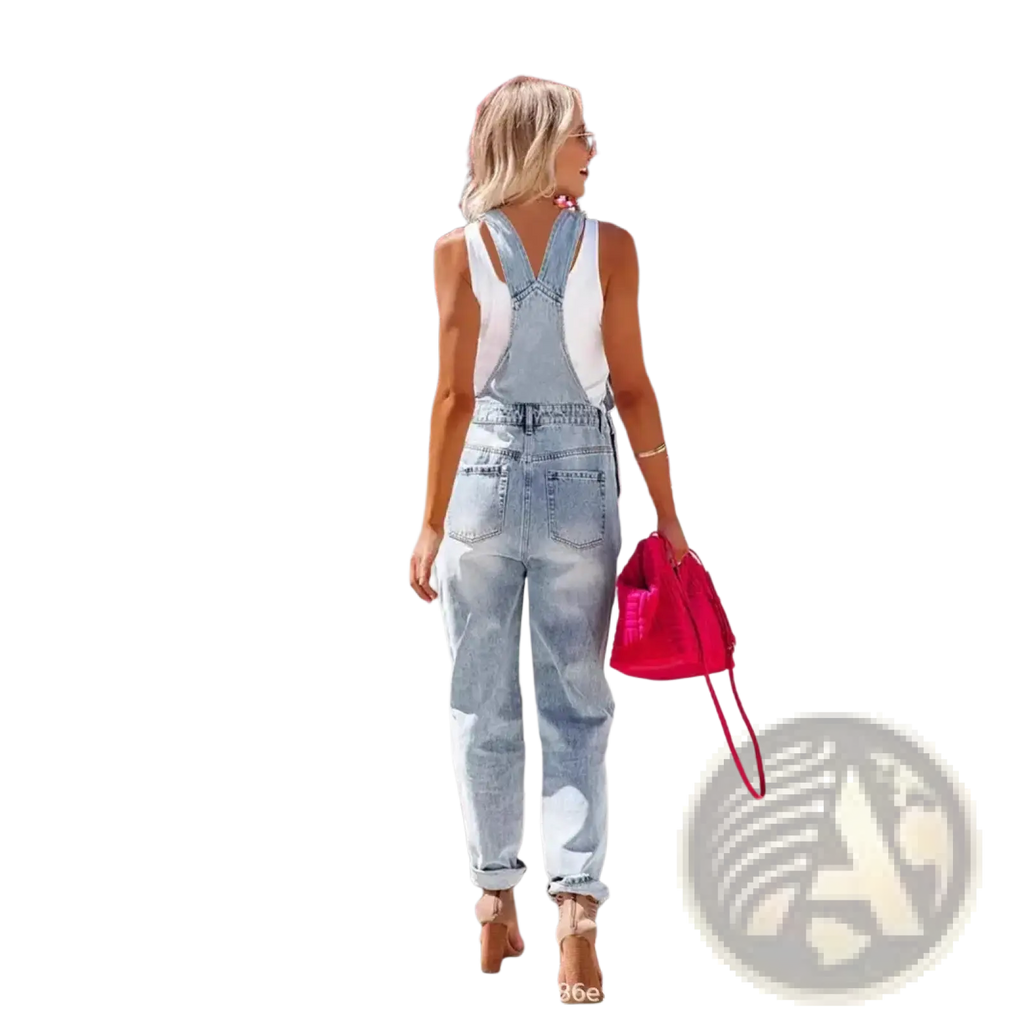 Back side of light-wash ripped denim overalls featuring white fabric panels on shoulders and back in jumpsuit style