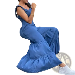 Blue denim ruffled flare jumpsuit featuring flowing maxi design with tiered hem and ruffled sleeves