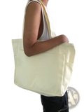 Cream-colored canvas denim tote bag with large capacity and single shoulder strap by Alma Latina