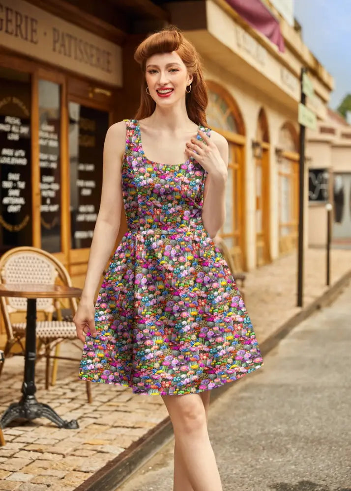 A vibrant sleeveless floral print cotton mini dress with square neckline and fitted waist from Desert Blooms