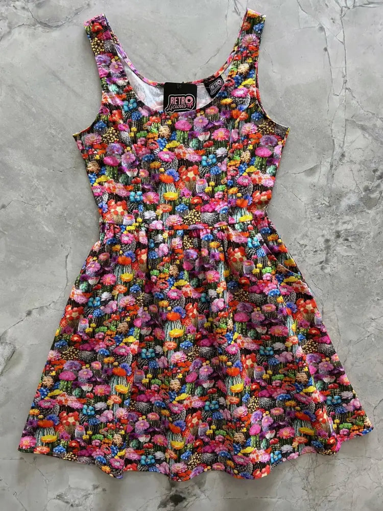 Desert Blooms sleeveless cotton fit and flare mini dress with vibrant floral print on a dark background