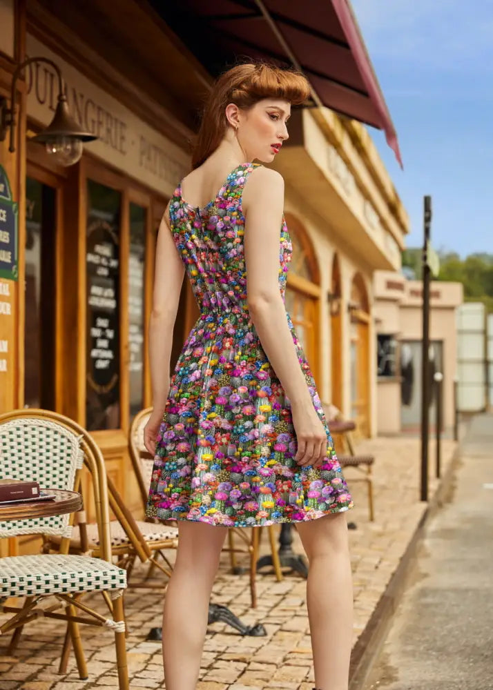 A vibrant sleeveless floral print cotton fit and flare mini dress with a fitted bodice and flared skirt Desert Blooms