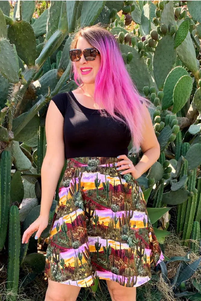 A vibrant multi-colored cotton a line skirt with a desert landscape print featuring cacti and sunset hues