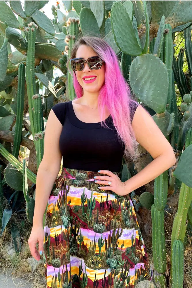 A full-length cotton a-line skirt with a desert cactus print in warm sunset hues and green tones
