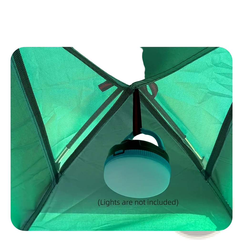 A translucent white camping lantern with a black handle hanging inside the green desert fox waterproof outdoor hiking tent