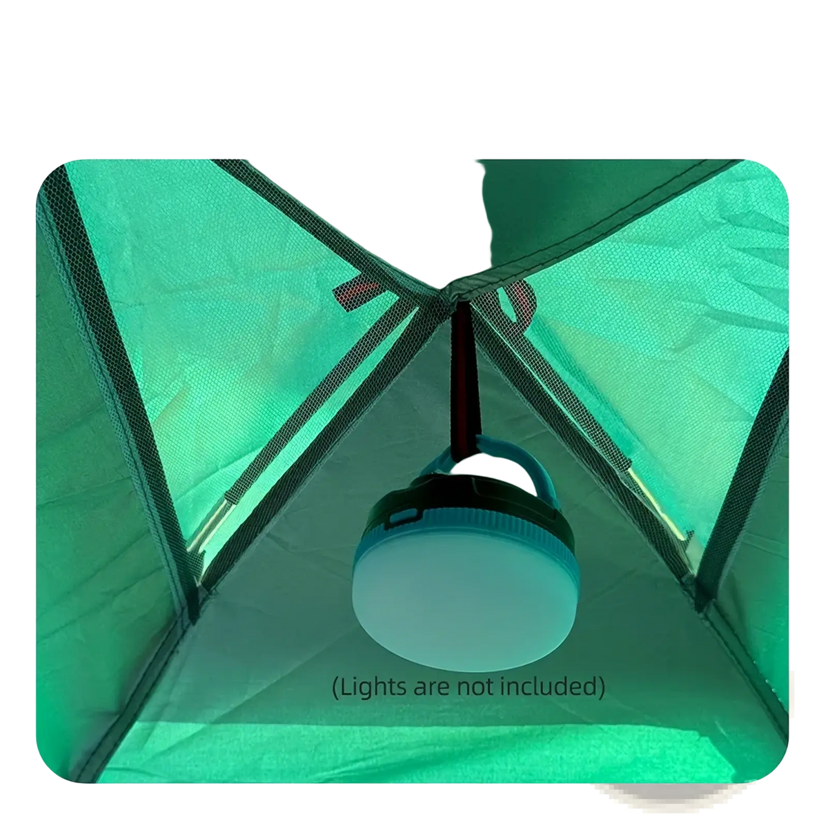A translucent white camping lantern with a black handle hanging inside the green desert fox waterproof outdoor hiking tent