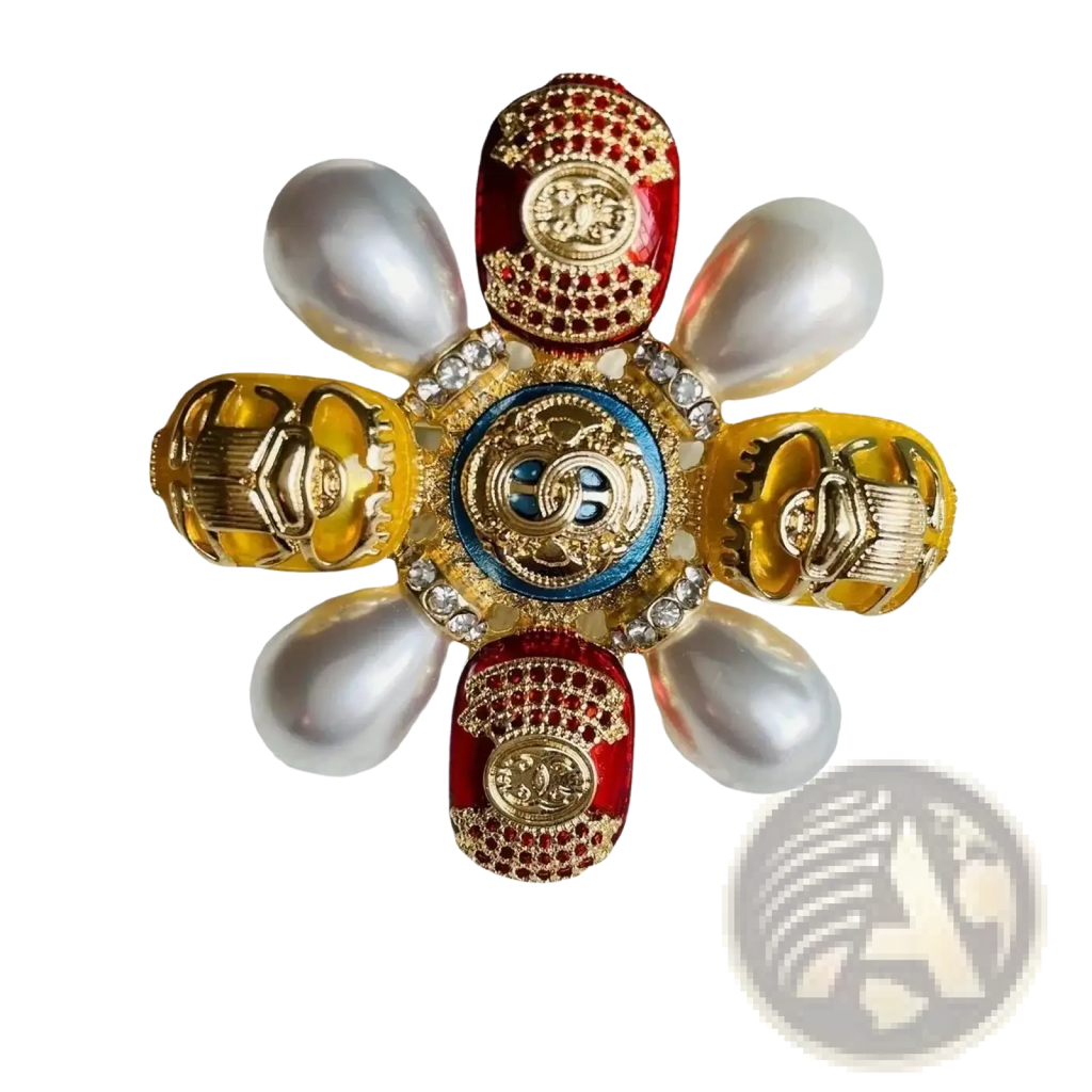 A luxurious Chanel designer pearl brooch with a blue enamel medallion and red yellow beetle rhinestone pin