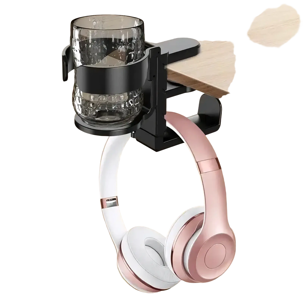 Black desk-mounted cup holder and headphone hook holding a textured glass cup and rose gold wireless headphones