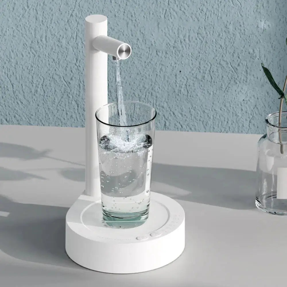 White minimalist rechargeable smart automatic gallon water bottle pump with sleek cylindrical spout pouring clear liquid into glass