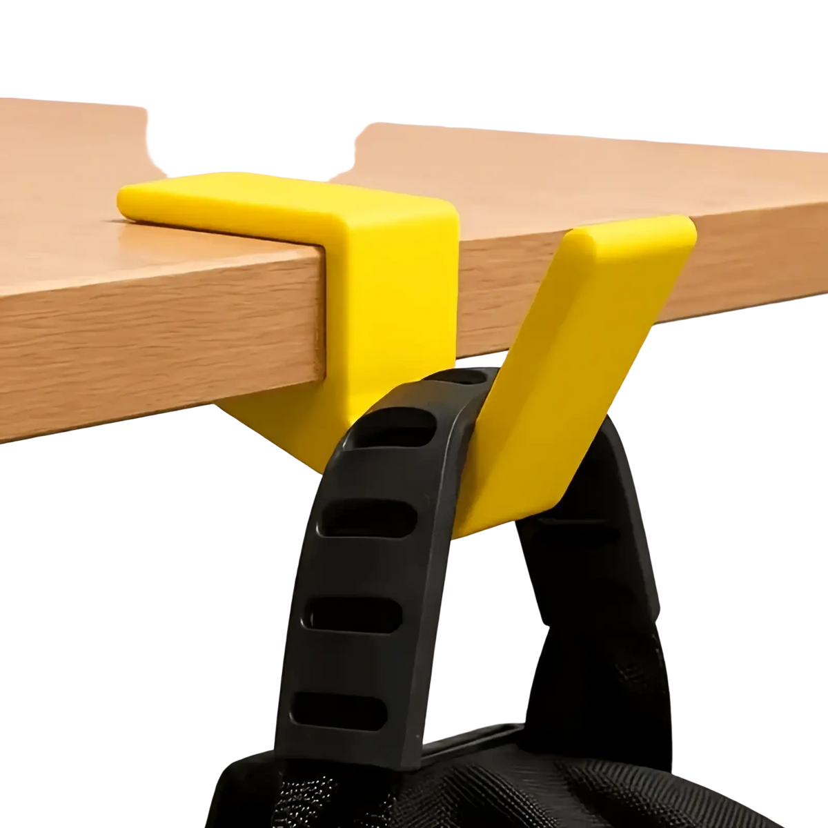 Bright yellow plastic desk-mounted backpack holder with black strap attachment for organizing bags on desk edge