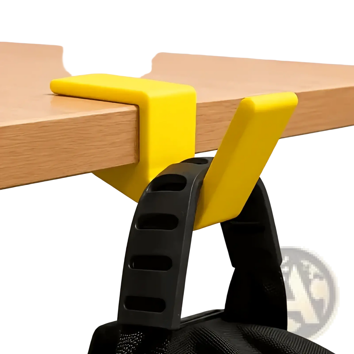 Bright yellow plastic desk-mounted backpack holder with black strap attachment for organizing bags on desk edge