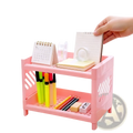 Pink two-tier plastic desk organizer with slotted sides and grid-patterned bottom shelf for efficient storage