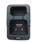 Black plastic desktop charger for th1n th9 thr8 radios with molded compartments and metallic contacts for secure charging