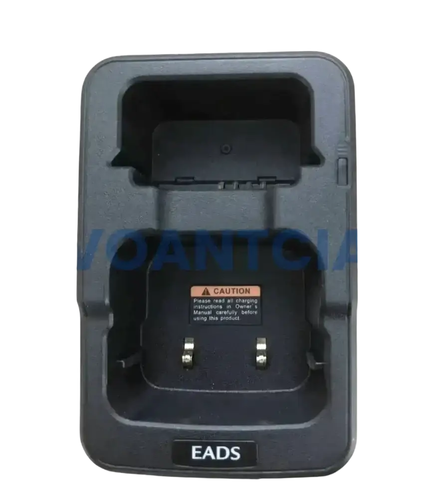 Black plastic desktop charger for th1n th9 thr8 radios with molded compartments and metallic contacts for secure charging