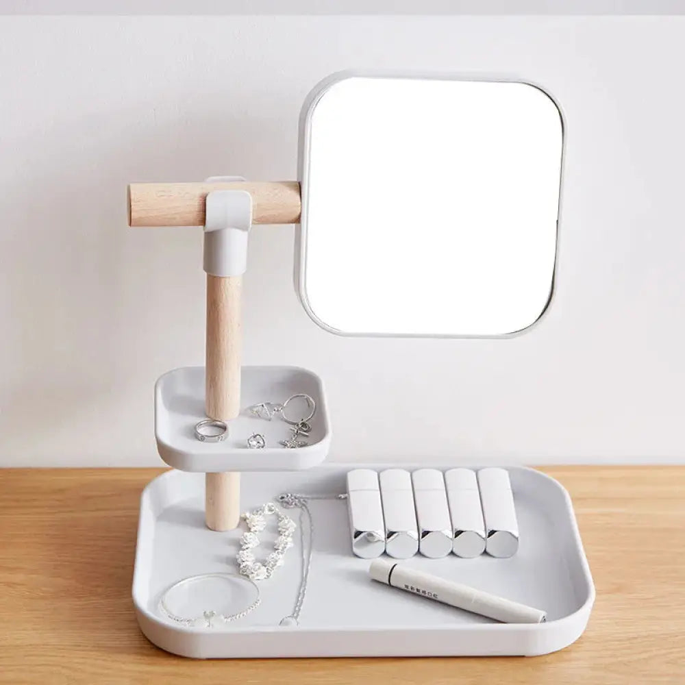 Minimalist cosmetics storage box with two white plastic trays, wooden handle, and adjustable square mirror on top