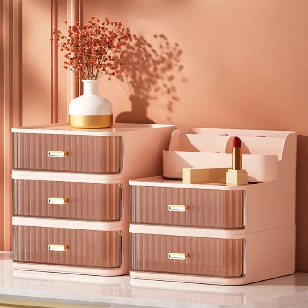 Modern two tiered desktop makeup and jewelry organizer with rose gold striped plastic drawers white accents and metallic handles