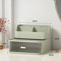 A sleek sage green two-tier desktop makeup and jewelry organizer with a translucent ridged drawer and gold-tone handle