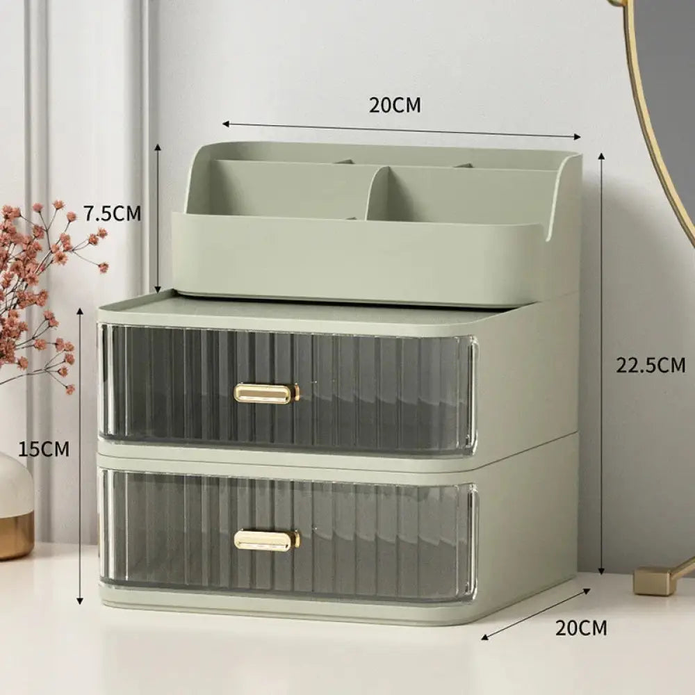 Modern two tiered desktop makeup and jewelry organizer in sleek sage green with translucent striped drawers and gold handles