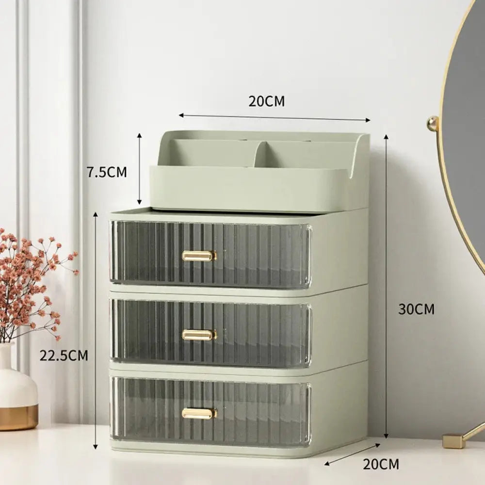 Modern two tiered desktop makeup and jewelry organizer in sage green with three translucent ribbed drawers and gold handles