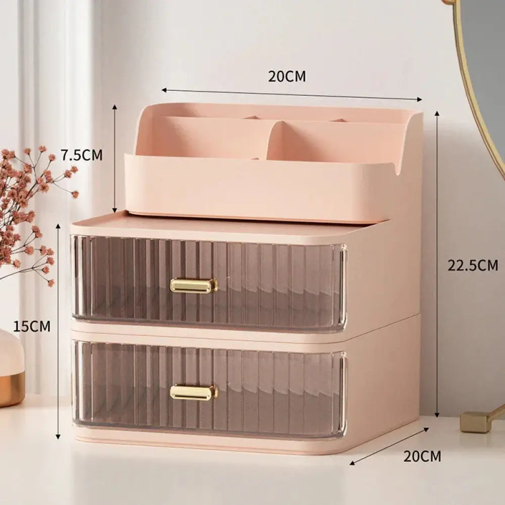 Modern two tiered desktop makeup and jewelry organizer with pastel pink translucent drawers and gold tone handles