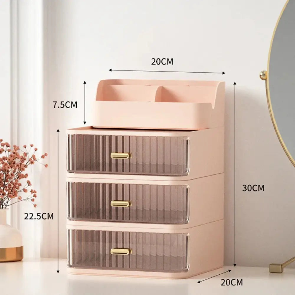 Pastel pink plastic modern two tiered desktop makeup and jewelry organizer with three translucent drawers and gold-tone handles