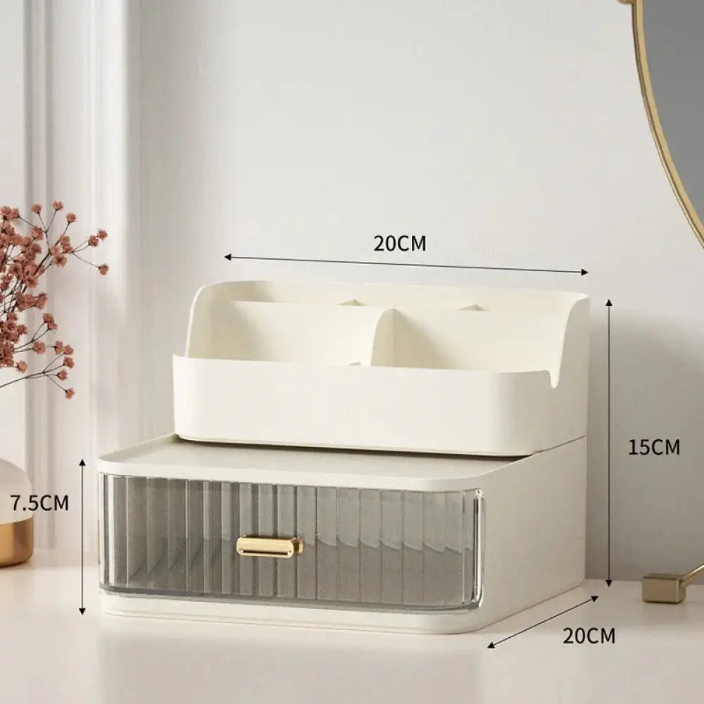 Modern two tiered desktop makeup and jewelry organizer in cream plastic with a translucent ridged drawer and gold handle