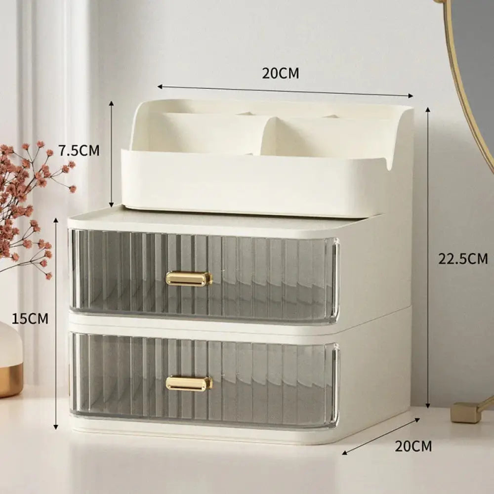Modern two tiered desktop makeup and jewelry organizer in cream with translucent ribbed drawers and gold-tone handles