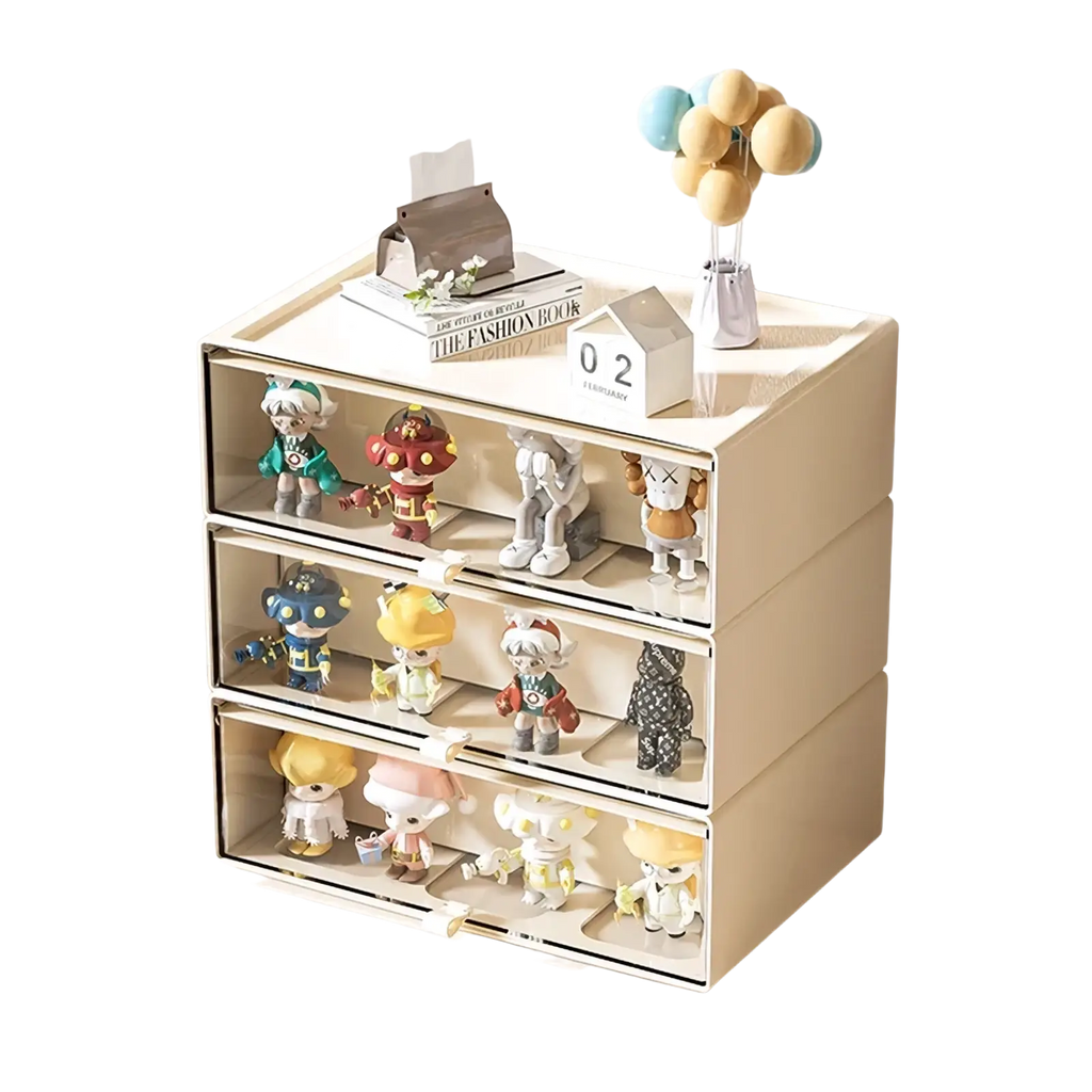 Beige three-drawer desktop organizer with clear fronts and white handles displaying colorful collectible figurines