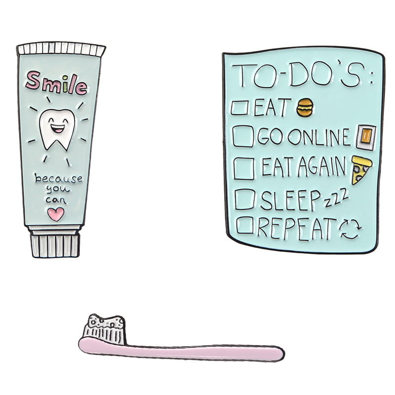 Mint green enamel pin shaped like a toothpaste tube featuring the word smile and a smiling tooth illustration designed as a cartoon tooth brooch.