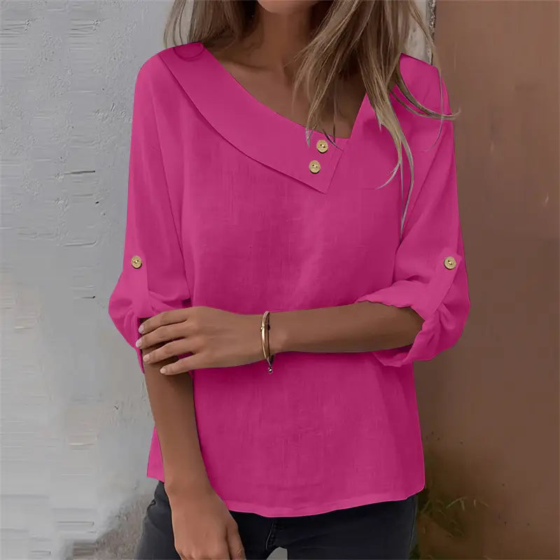 Bright pink asymmetric button blouse featuring a lightweight fabric v-neck collar and three-quarter sleeves with gold-tone buttons.