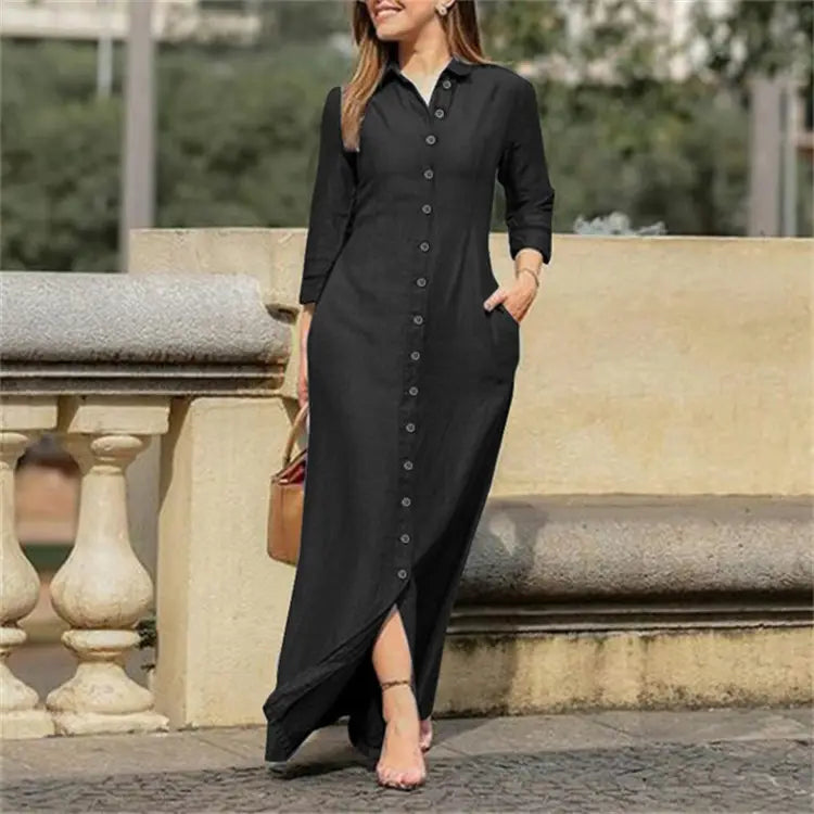 Black long-sleeved button-down maxi dress with a side slit and front pockets in denim material.