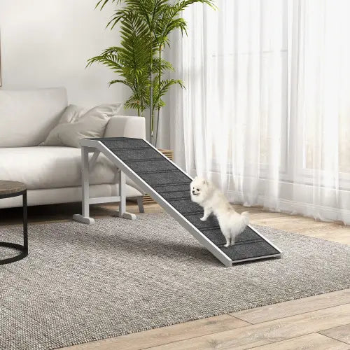 Rampa para cama de perro con marco plateado y superficie de alfombra antideslizante negra con textura, diseñada para la seguridad y comodidad de las mascotas.